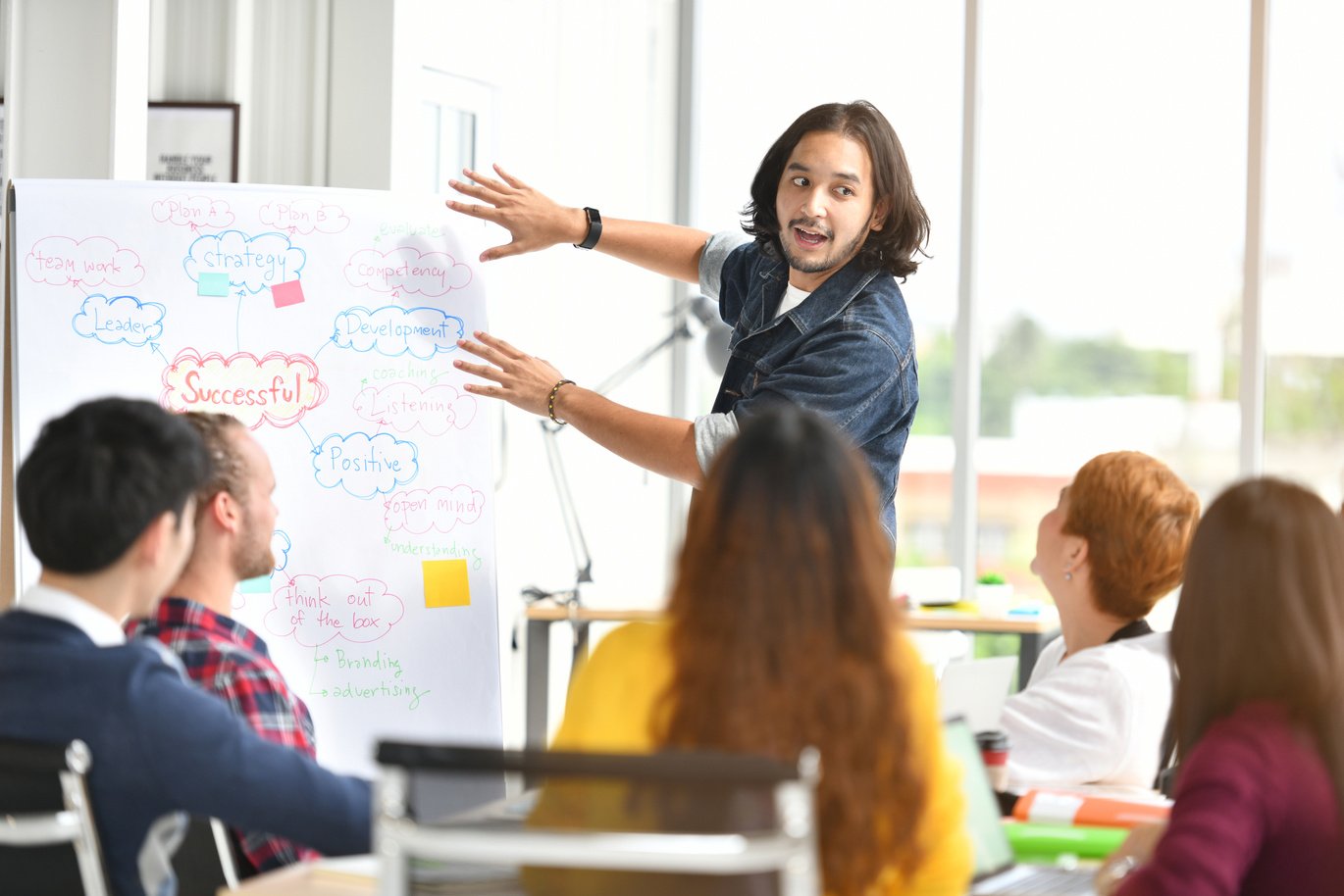 Young Businessman Giving Presentation in a Meeting